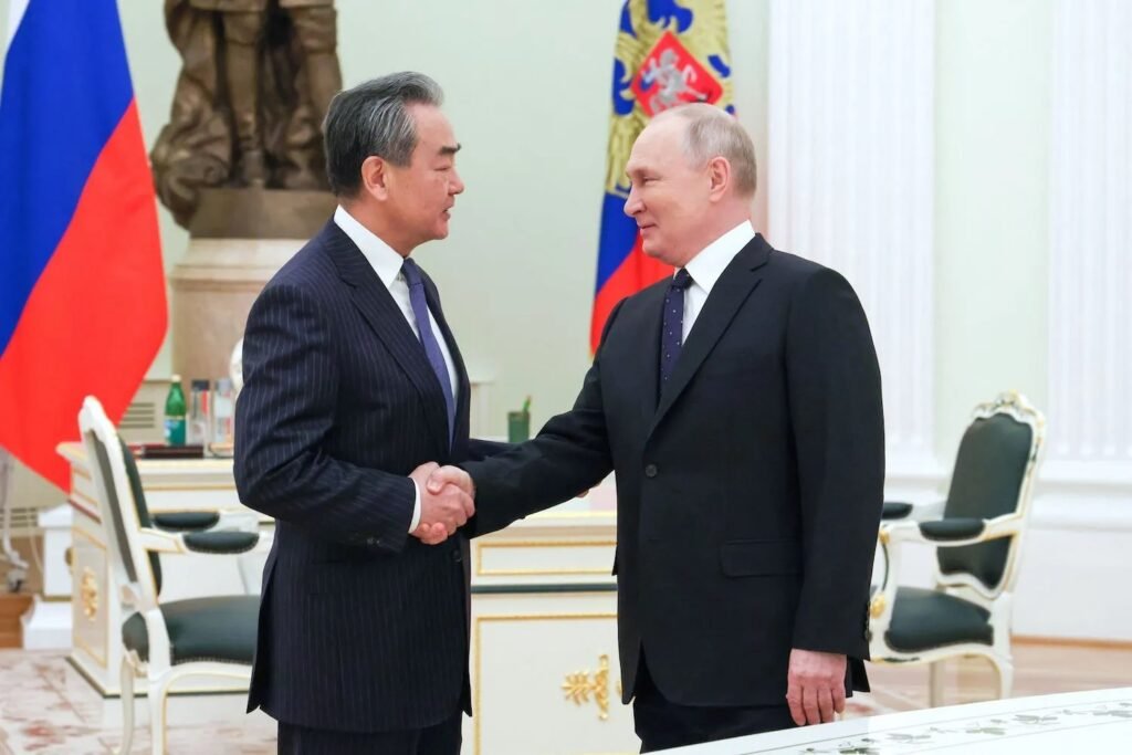 China's foreign minister Wang Yi with Russian president Putin during his Moscow visit on February 23/ Image source: Reuters